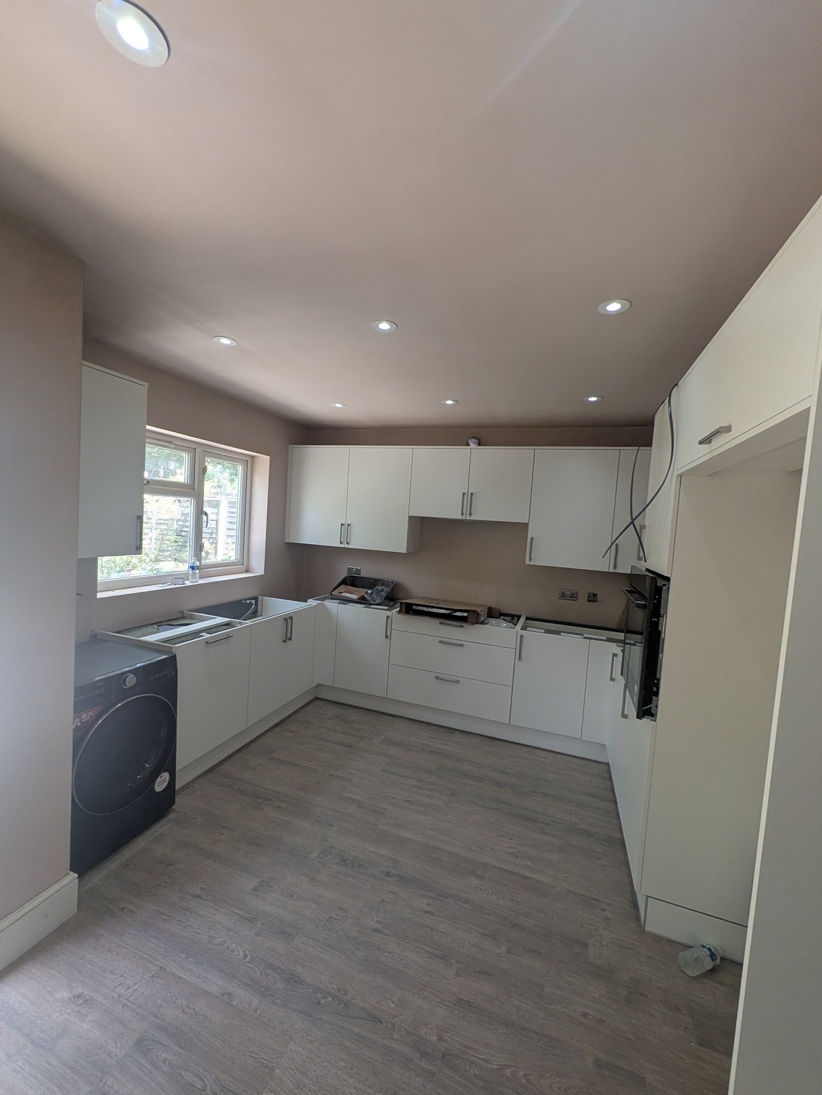 Edgware HA8 kitchen stripped back to bare carcasses and exposed wiring, before