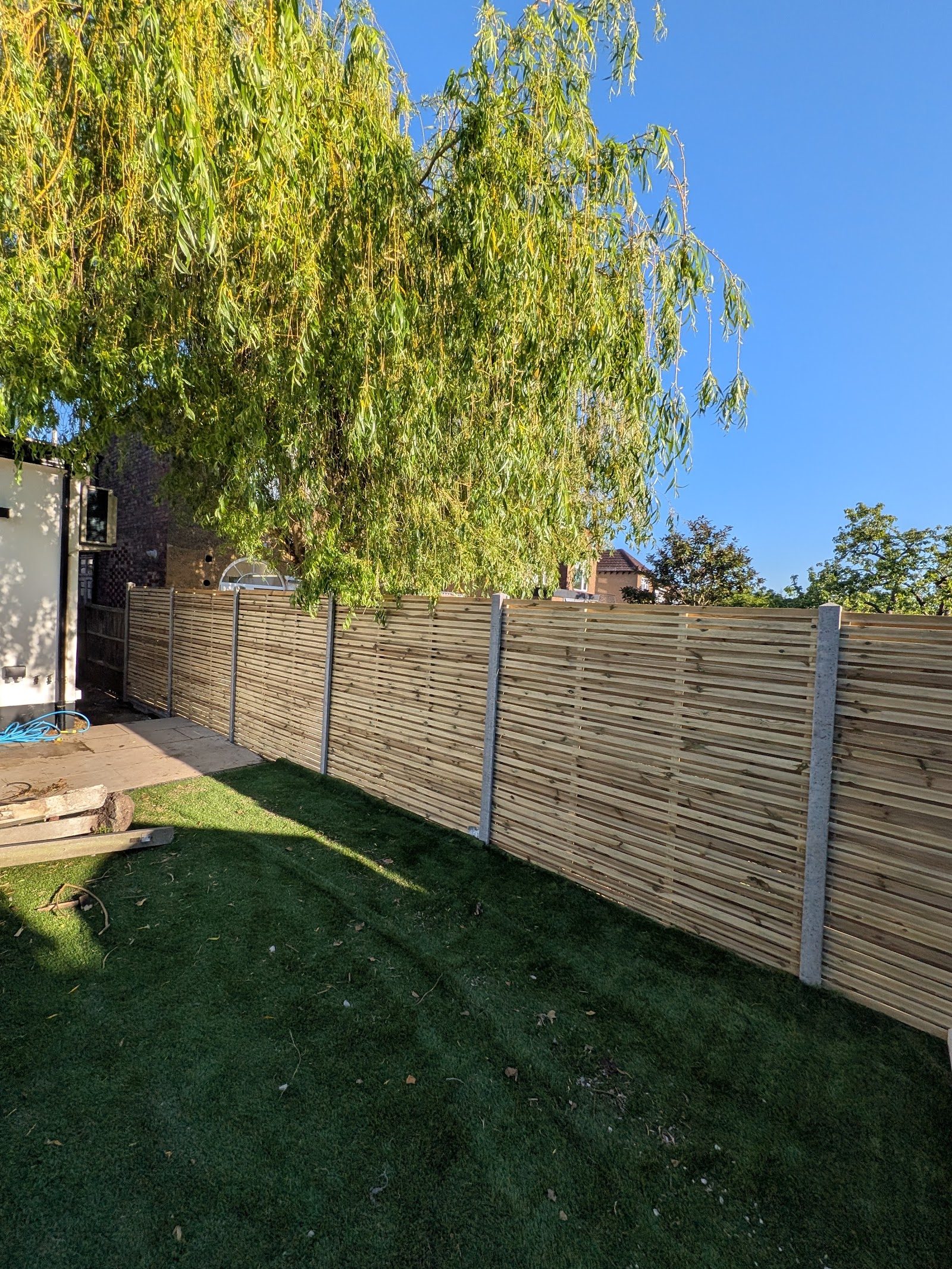 New slatted fence and lawn in the same Finchley N3 garden, after
