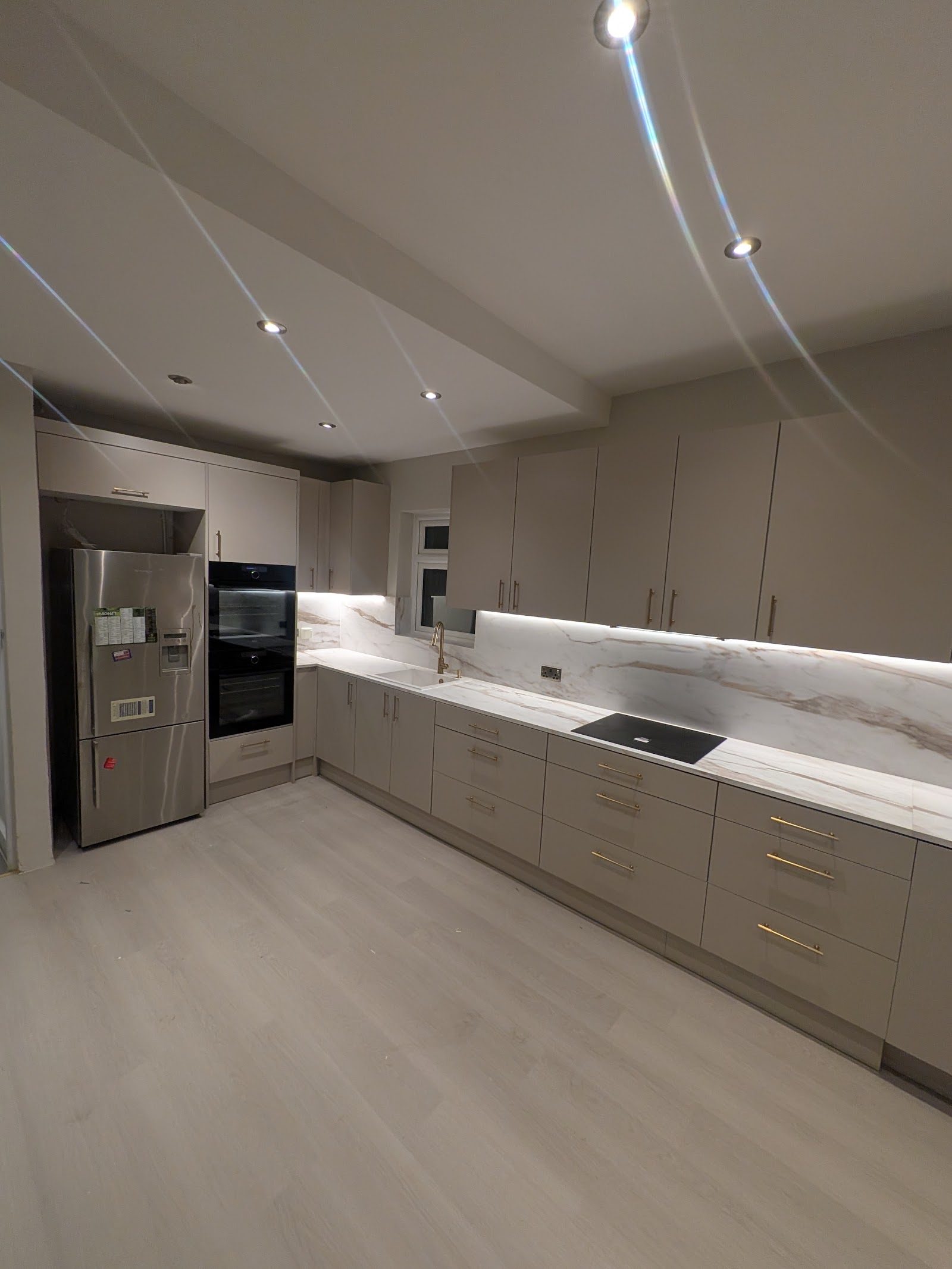 Handleless kitchen with marble worktop and brass hardware, Golders Green NW11