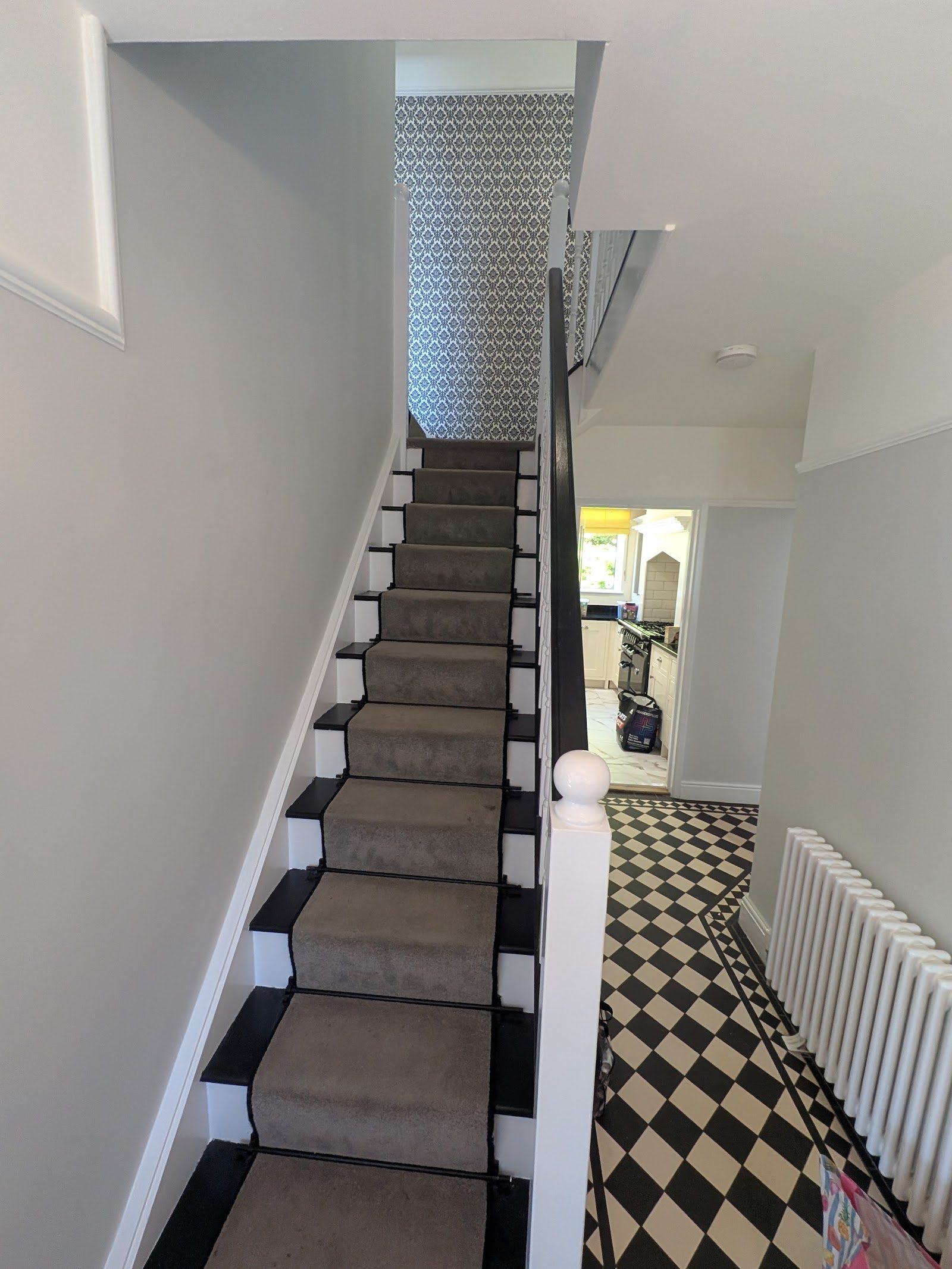 Staircase and hallway with patterned wallpaper and checkerboard floor, Pinner HA5