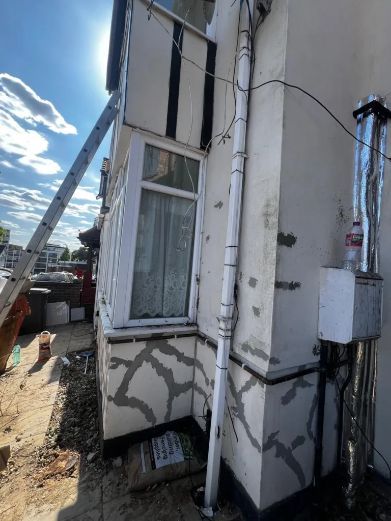 Cracked and streaked exterior render before repainting, Edgware HA8