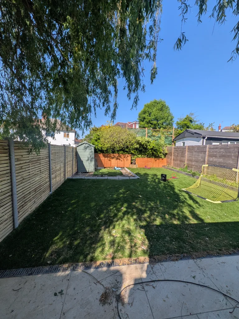 Garden area with new turf, edging and fencing after landscaping, Finchley N3