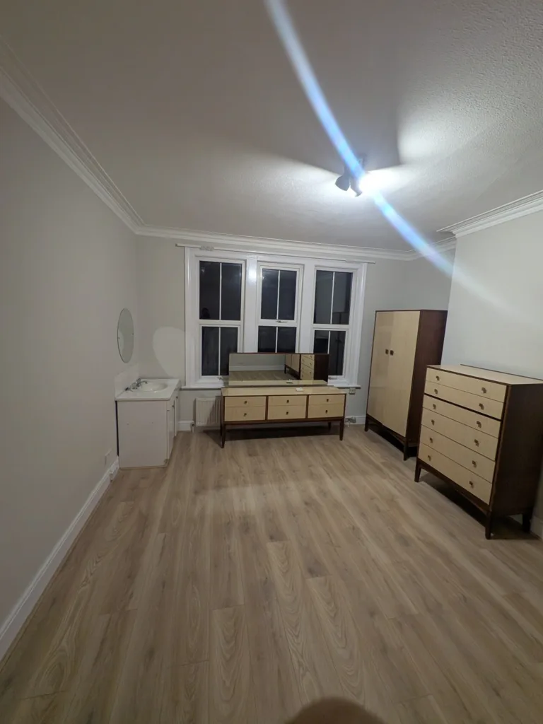 The same Golders Green NW11 bedroom redecorated in grey with new oak laminate flooring