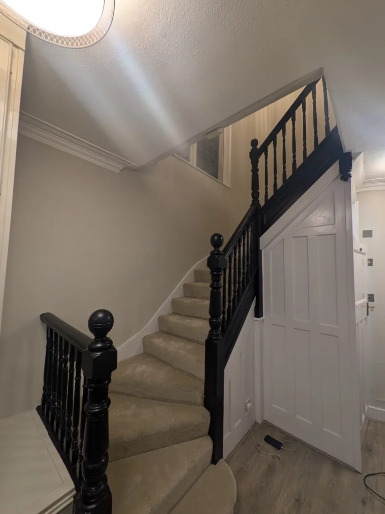 Hallway staircase repainted with black banister after redecoration, Golders Green NW11
